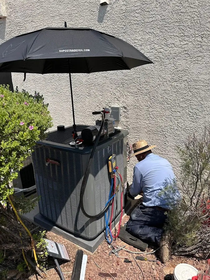 HVAC technician performing outdoor AC maintenance in Tehaleh